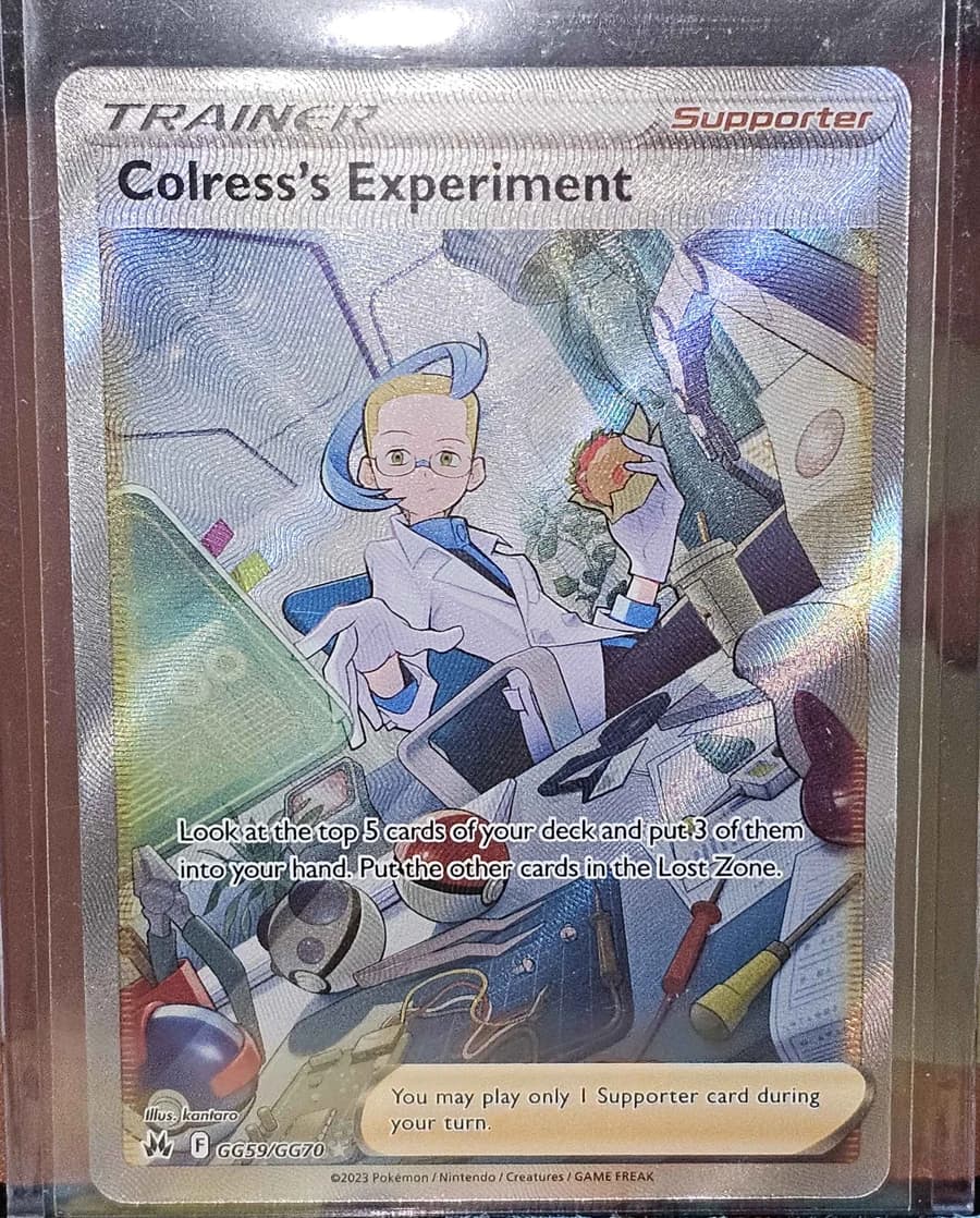 My copy of Colress's Experiment, Crown Zenith GG59, photographed straight on. Colress at a cluttered workbench with blueprints, a wrench, two Poké Balls and a mug.